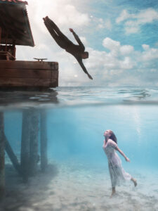 split underwater photo. Boy and girl in love. couple underwater in bonaire.